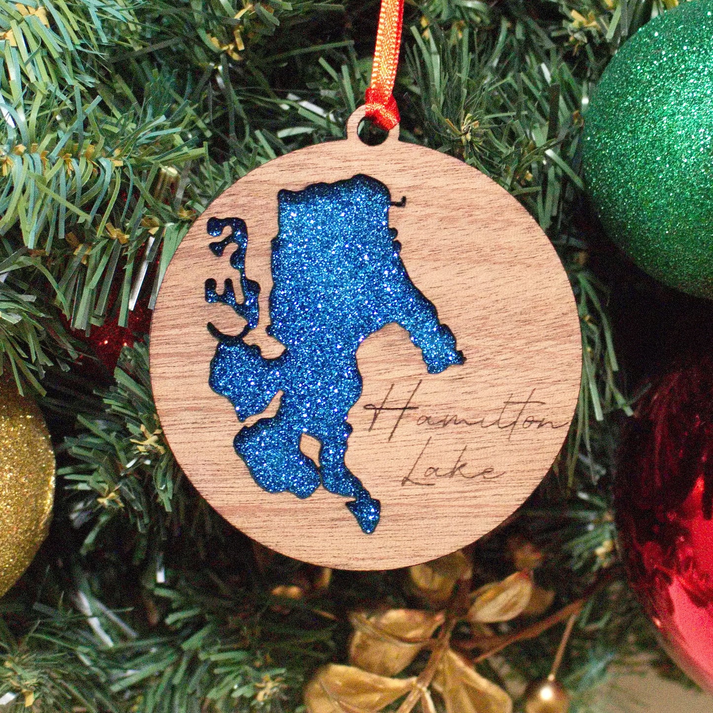 Hamilton Lake Christmas ornament for the family to remember time spent together on the lake. Made out of wood and acrylic with attention to detail. This is something you will love.